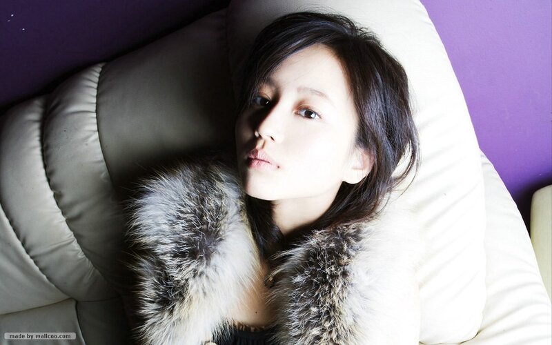 woman in fur coat lying down