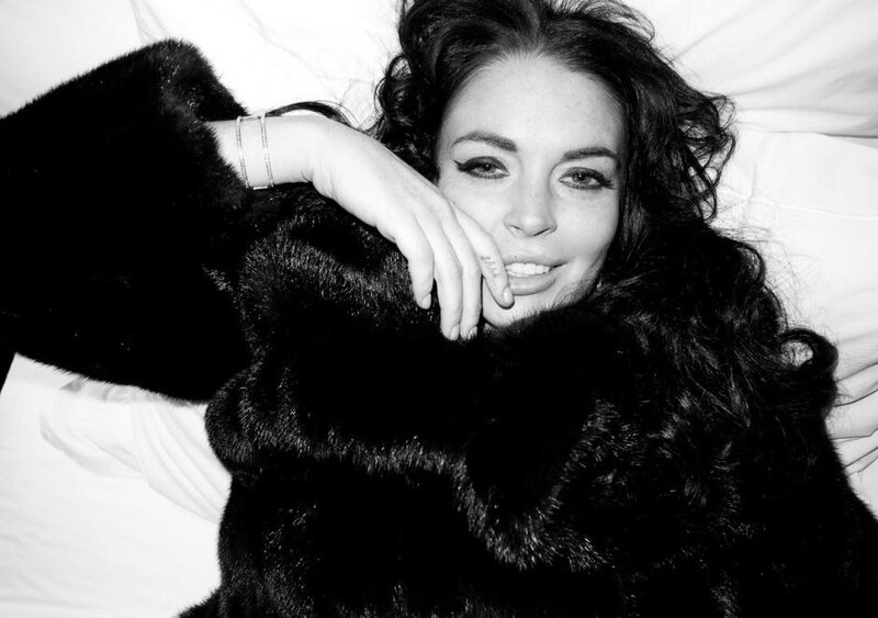 woman in fur coat lying down