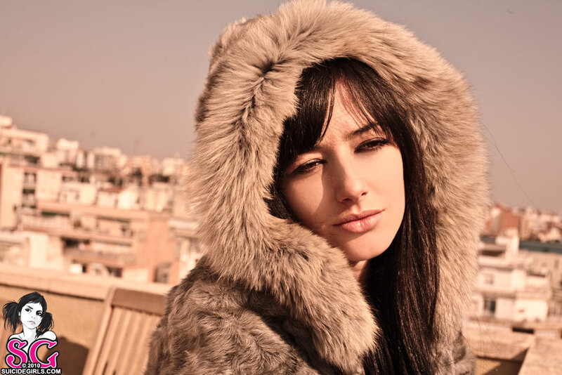 woman in fur coat on rooftop