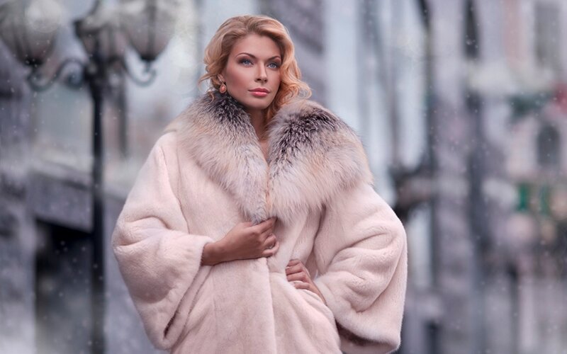 Woman in fur coat on snowy street