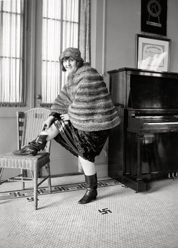 Woman in fur coat posing indoors