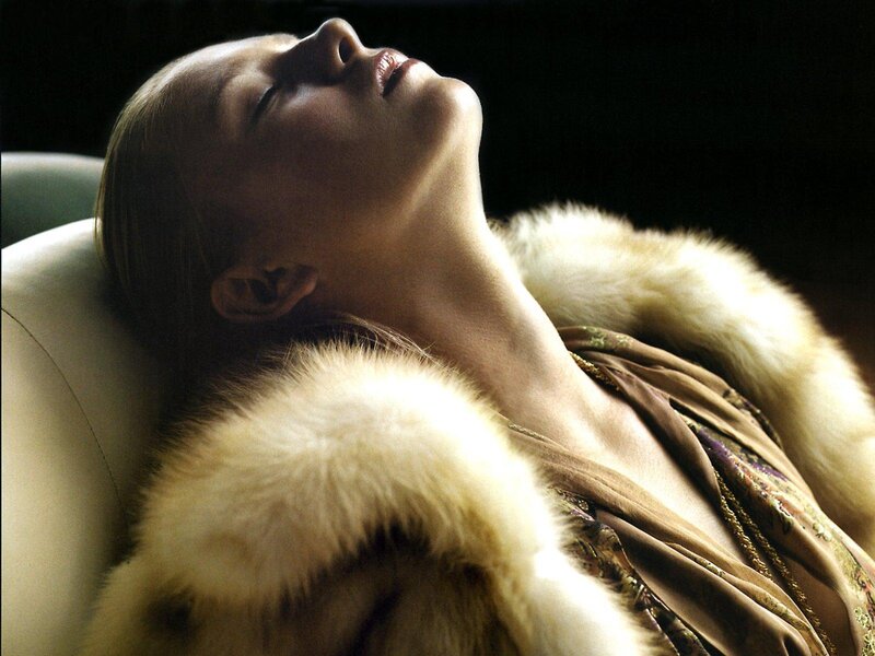 woman in fur coat resting