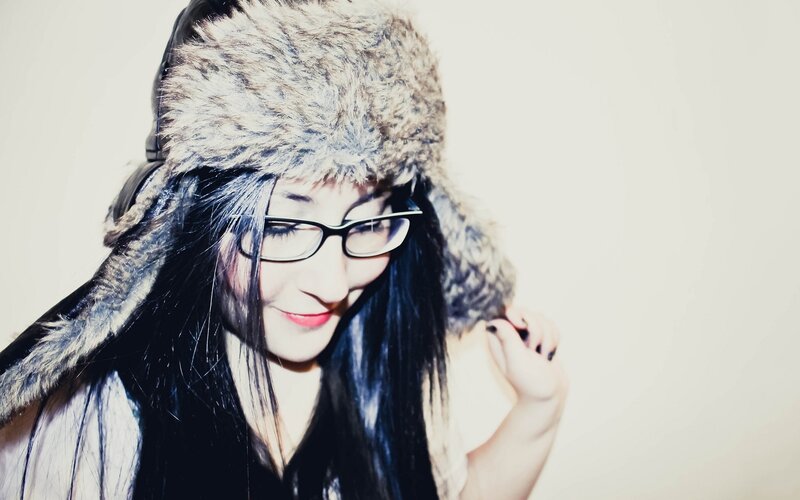 woman in fur hat and glasses