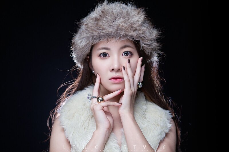 woman in fur hat and vest