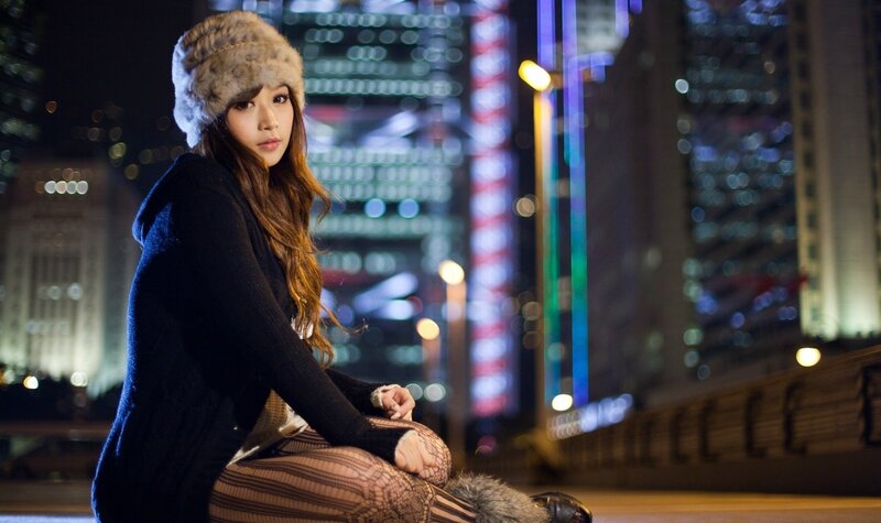 Woman in fur hat at night