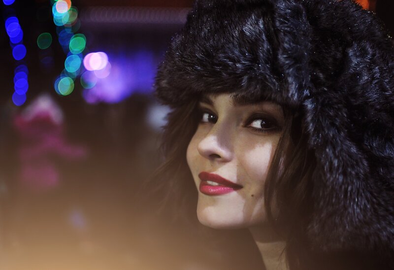 woman in fur hat at night