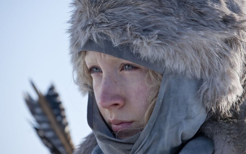 woman in fur hat holding arrow