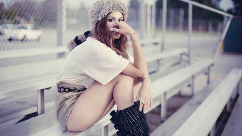 woman in fur hat on bleachers