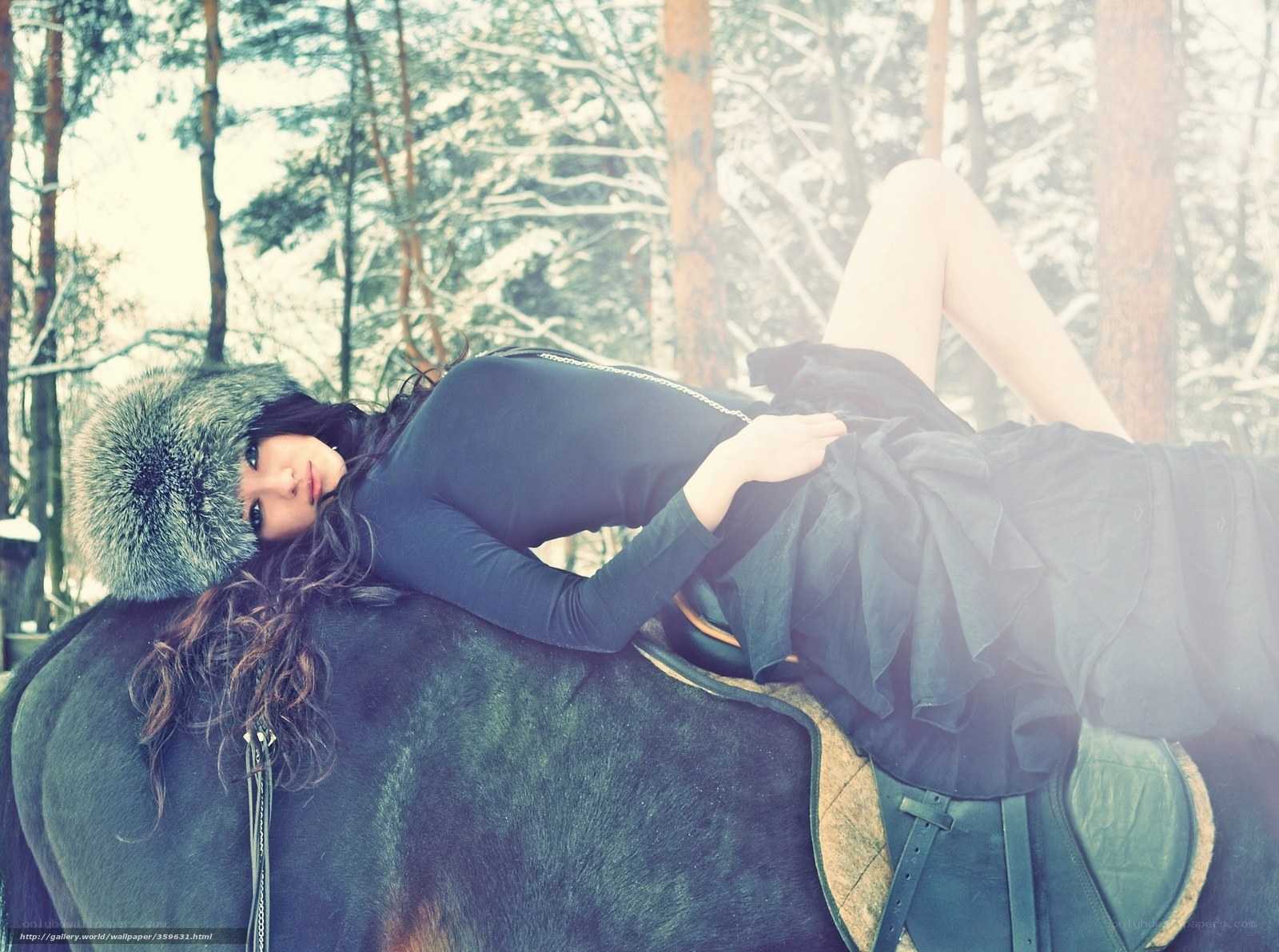 woman in fur hat on horse