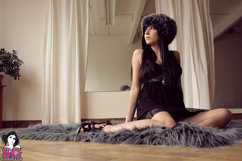 woman in fur hat sitting on rug