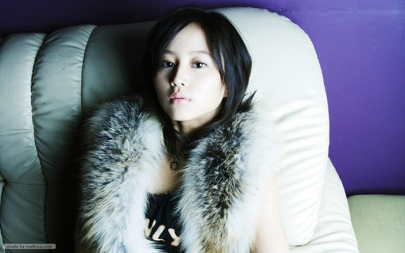 woman in fur vest on couch