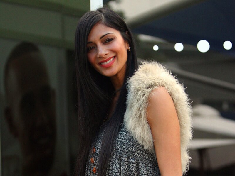 woman in fur vest smiling