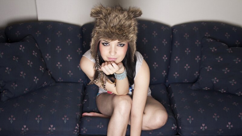 woman in furry hat on couch
