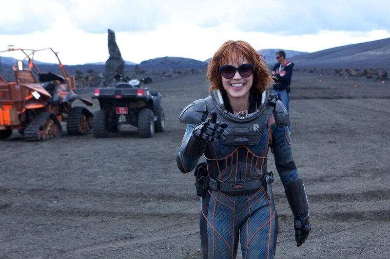 woman in futuristic suit on alien planet