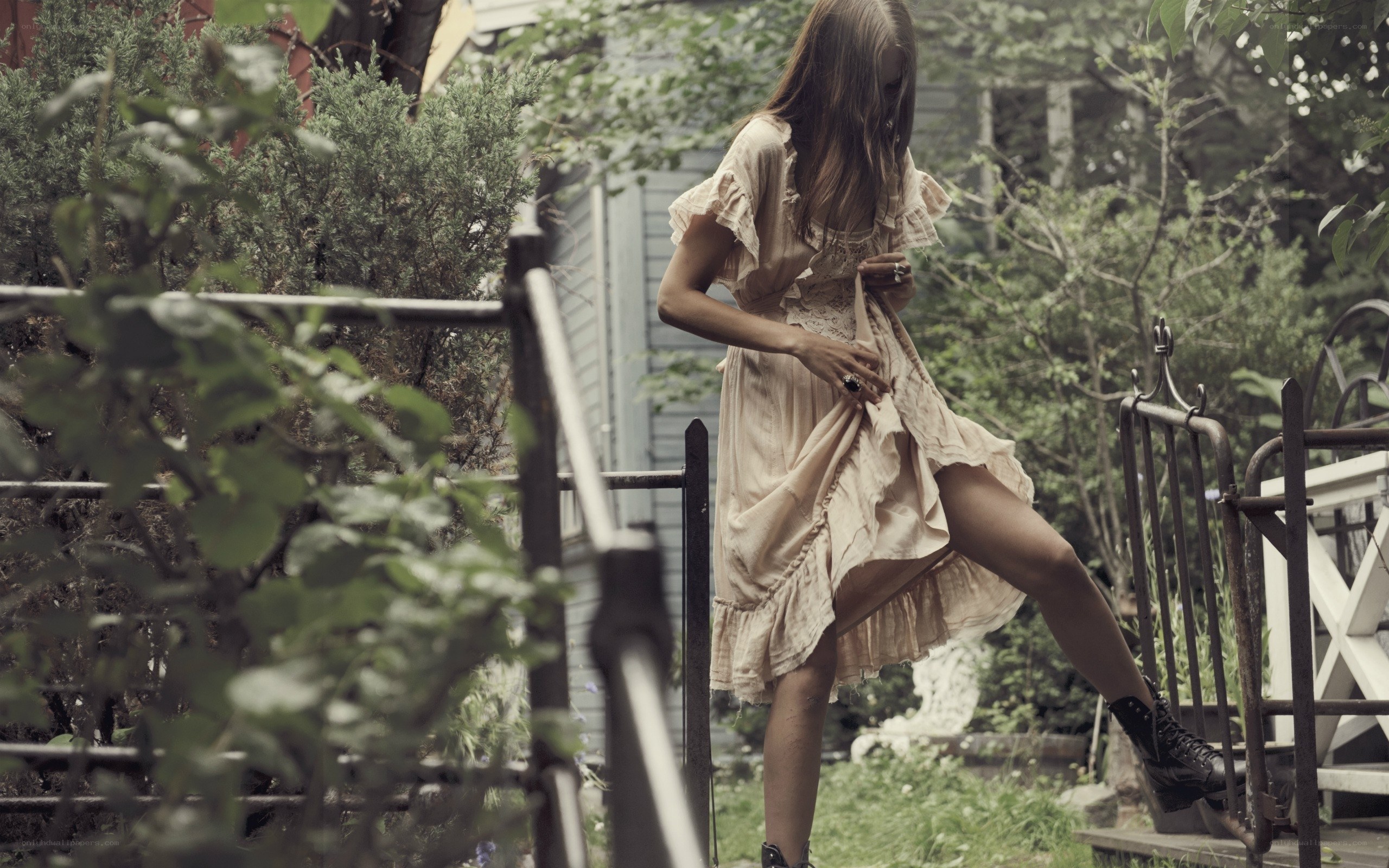 woman in garden adjusting dress