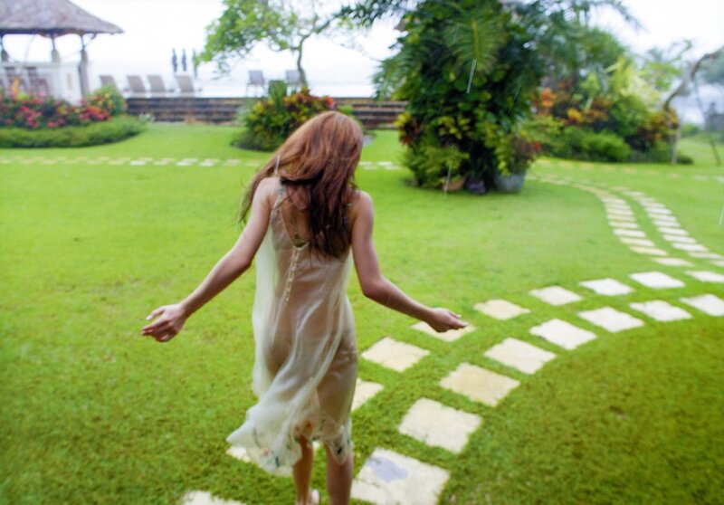 Woman in garden during rain