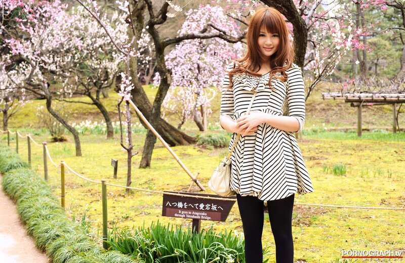Woman in garden with cherry blossoms
