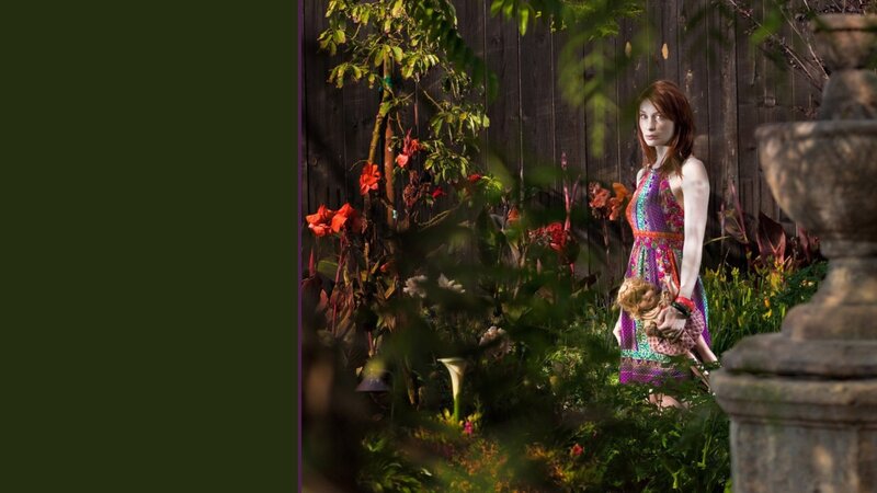 Woman in garden with doll