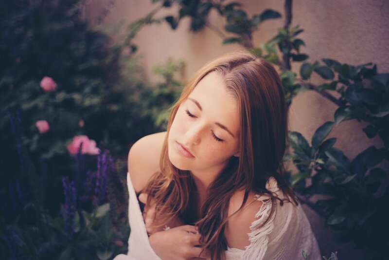 woman in garden with eyes closed