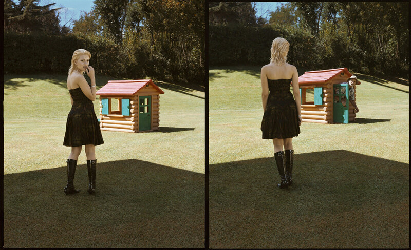Woman in garden with playhouse