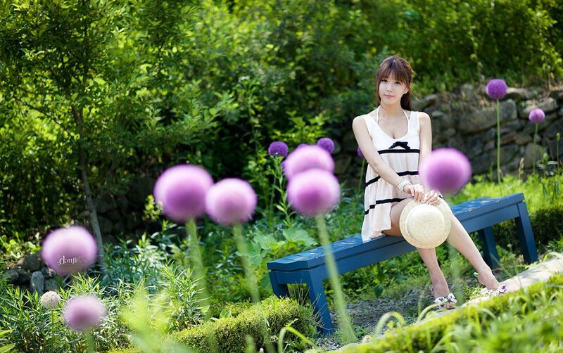 Woman in garden with purple flowers