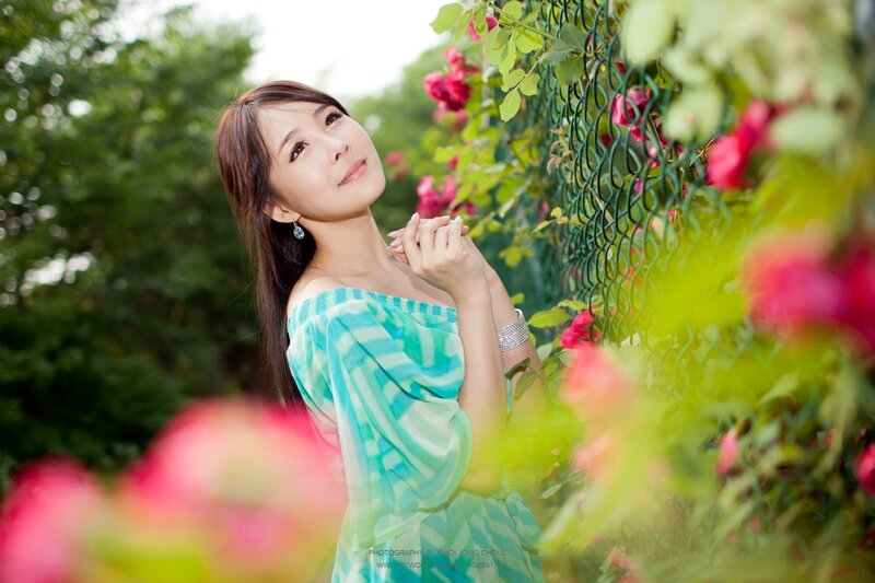 woman in garden with roses