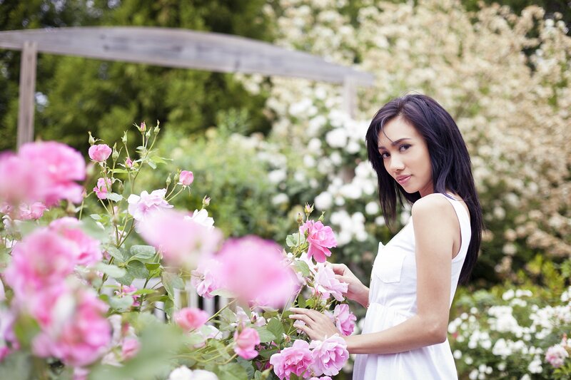 woman in garden with roses
