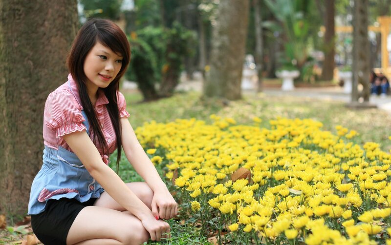Woman in garden with yellow flowers