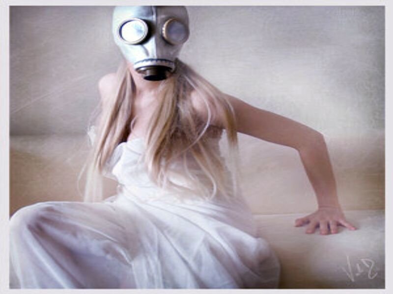 woman in gas mask on couch