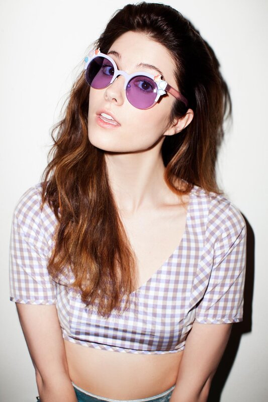 woman in gingham top and sunglasses