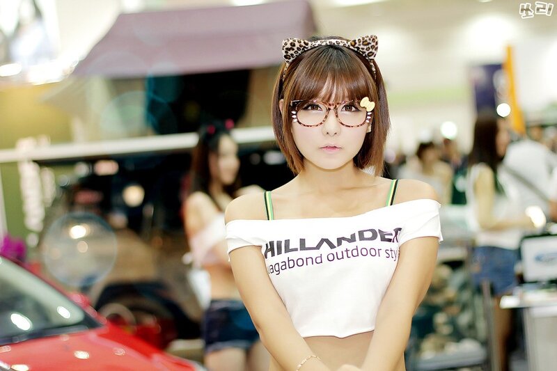 woman in glasses at auto show