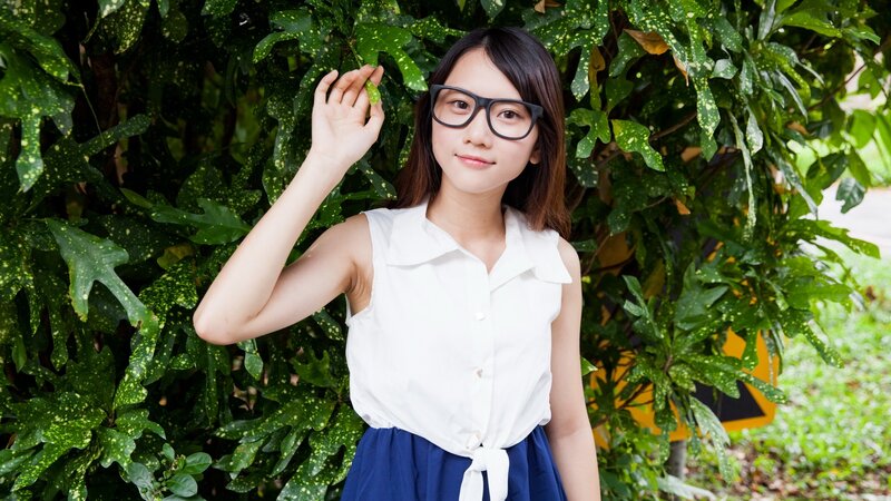 woman in glasses by green plants