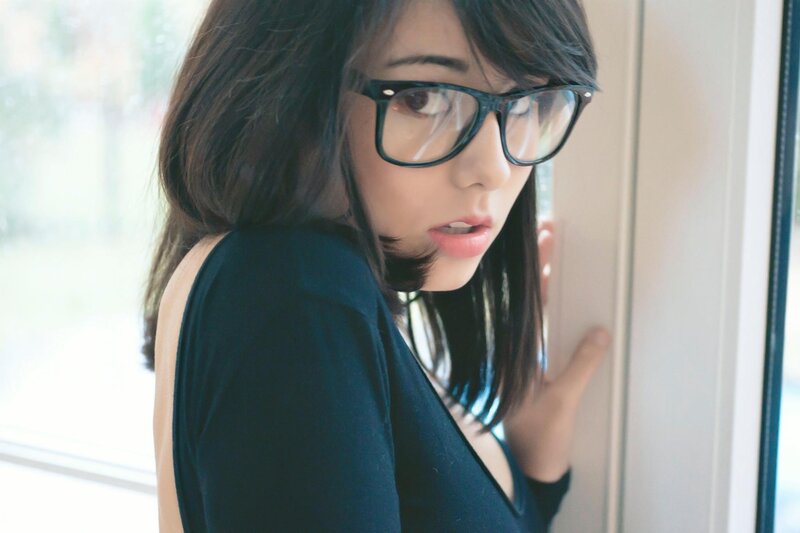 woman in glasses by window