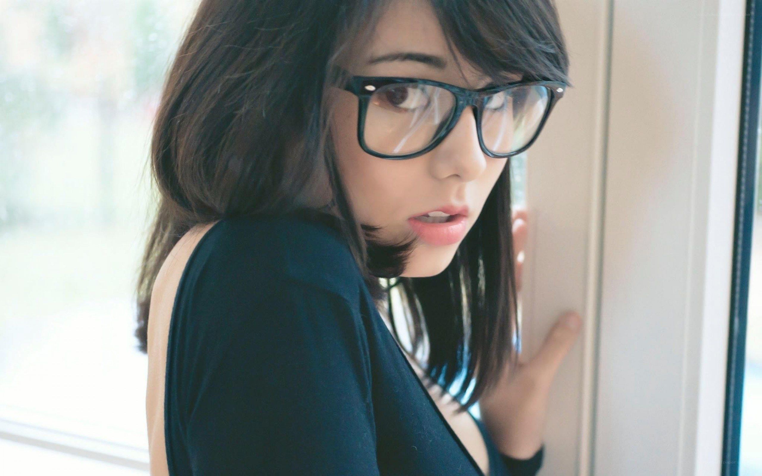 woman in glasses by window