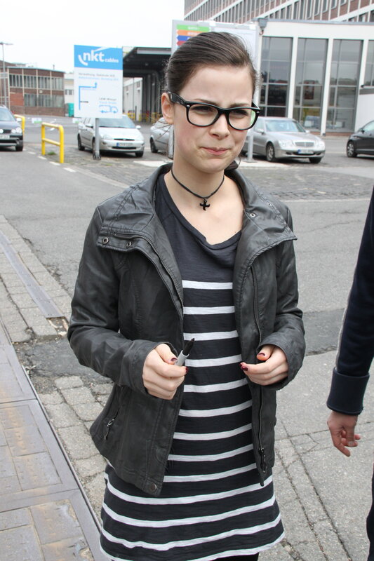 woman in glasses holding marker