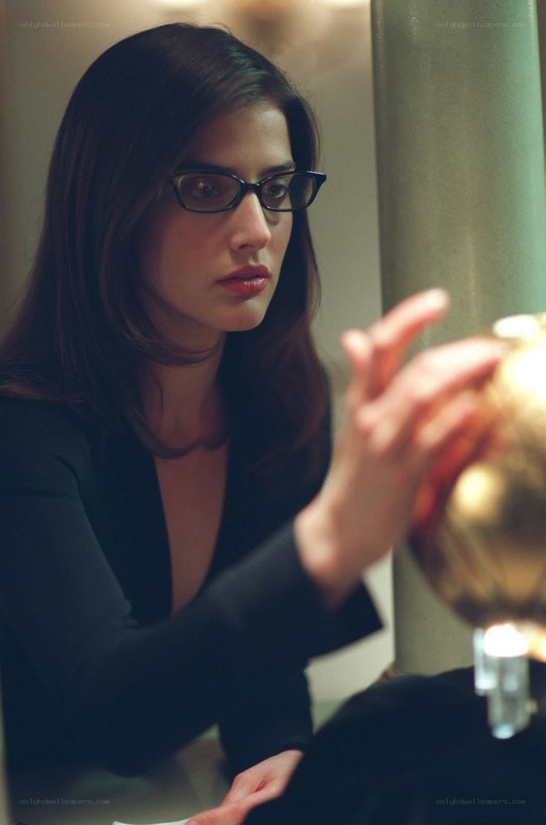 woman in glasses holding object