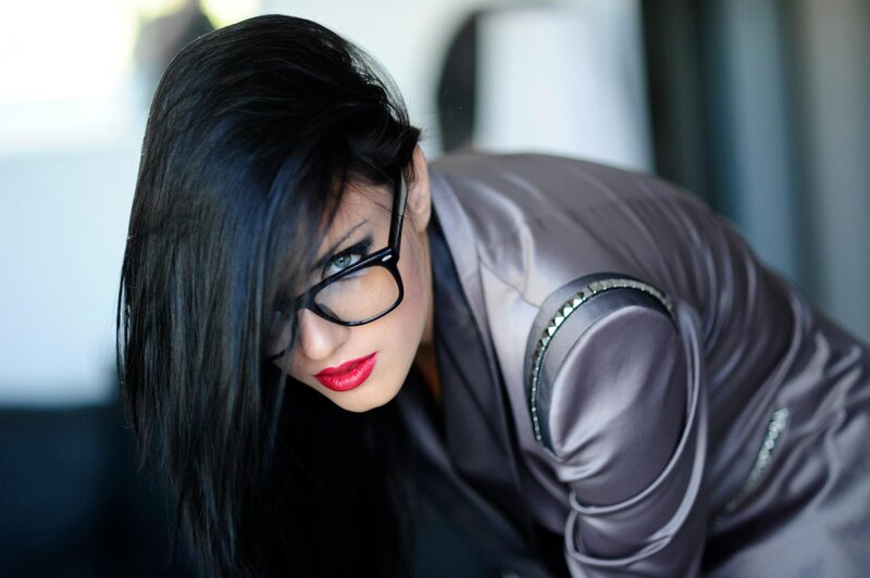 woman in glasses leaning forward