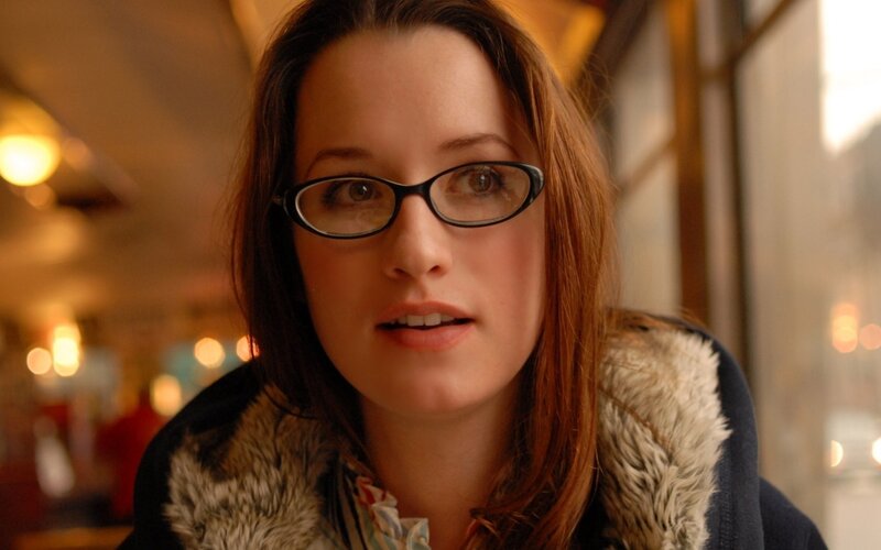 woman in glasses looking at camera