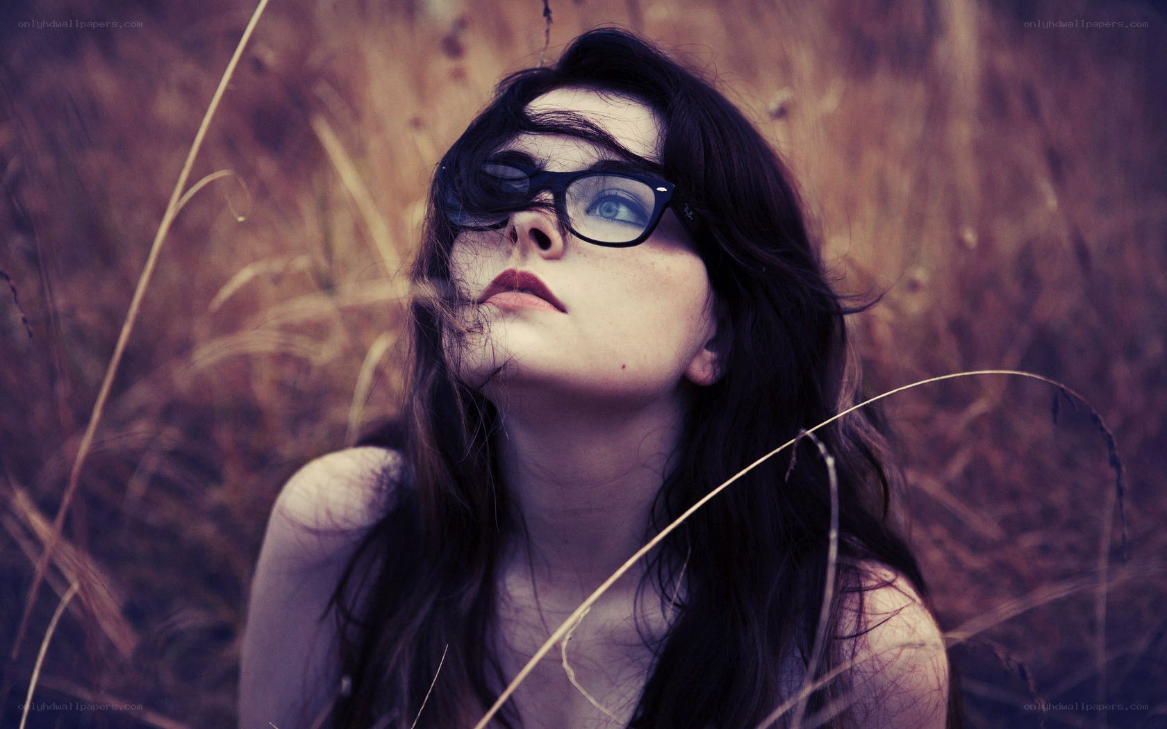 woman in glasses looking up