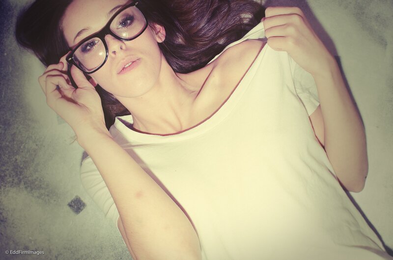 woman in glasses lying down