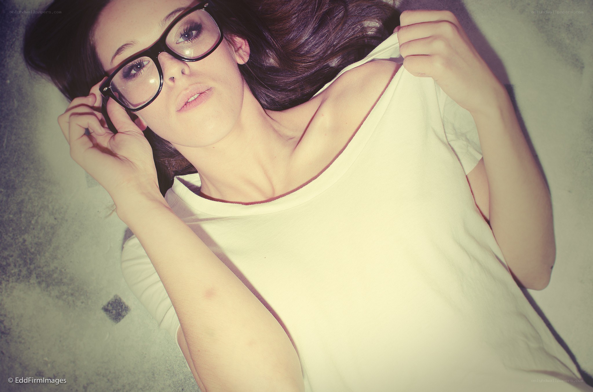 woman in glasses lying down
