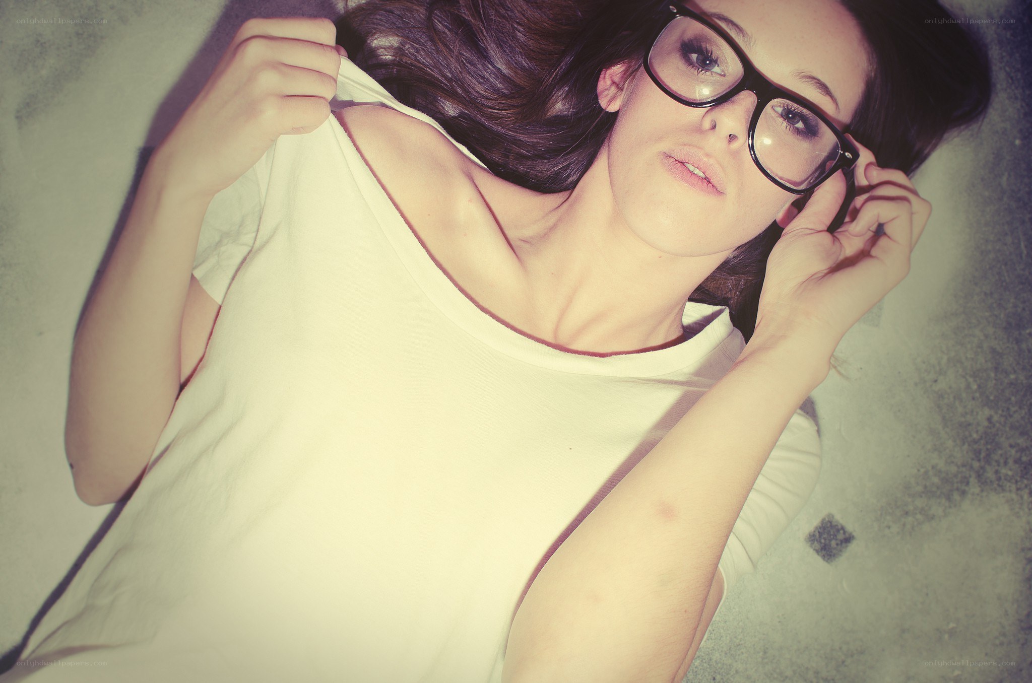 woman in glasses lying down