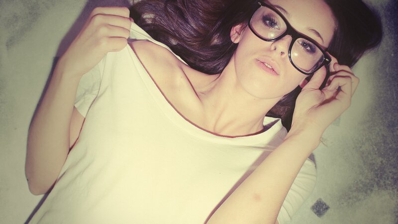 woman in glasses lying down