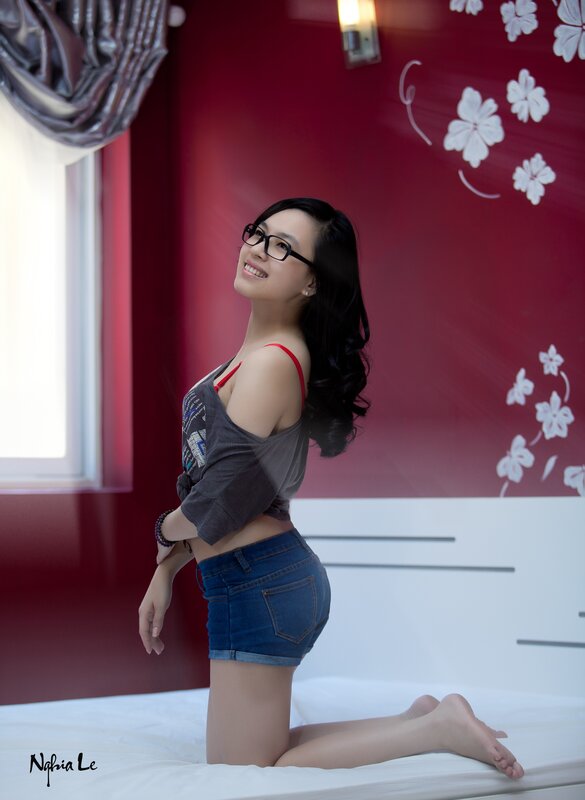 woman in glasses on bed
