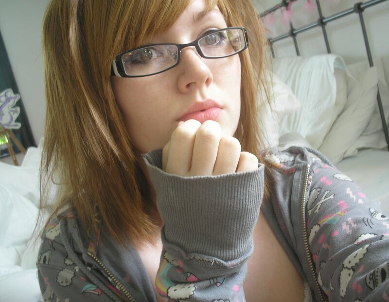 woman in glasses on bed