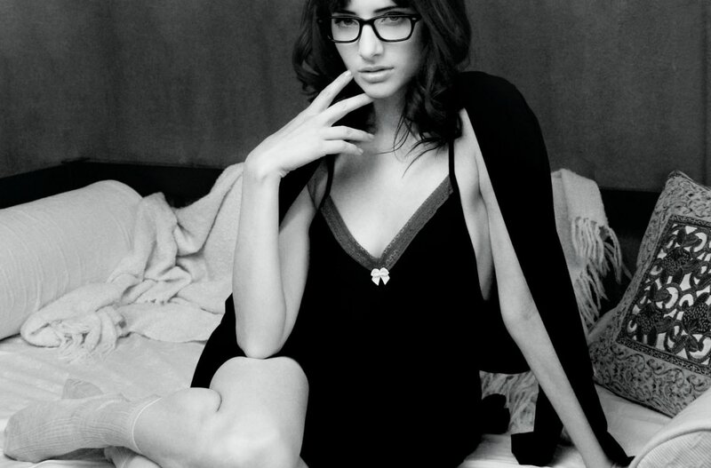 woman in glasses on bed