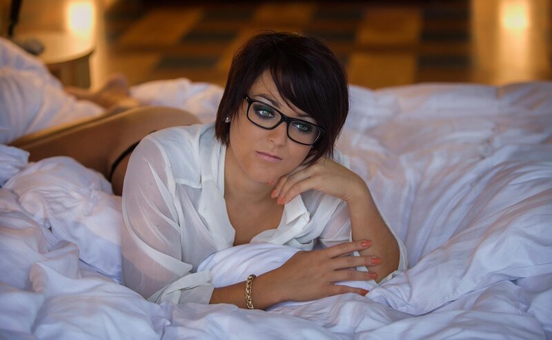 woman in glasses on bed