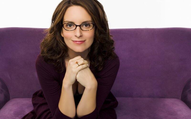 woman in glasses on purple couch