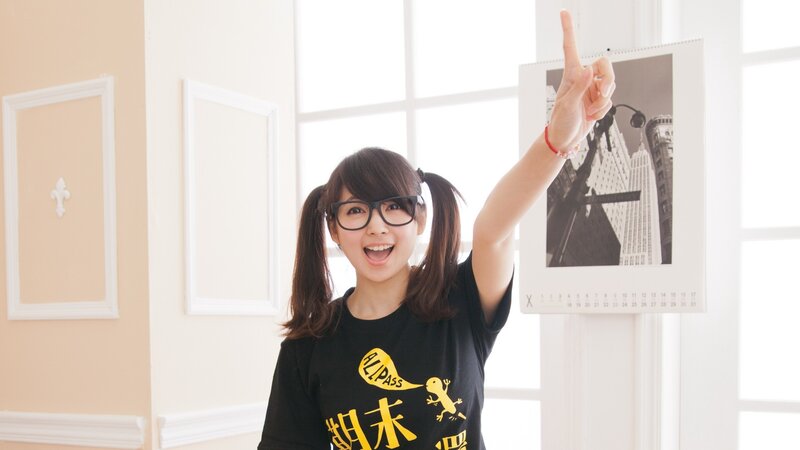 woman in glasses pointing up