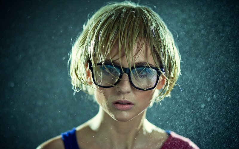 woman in glasses under rain